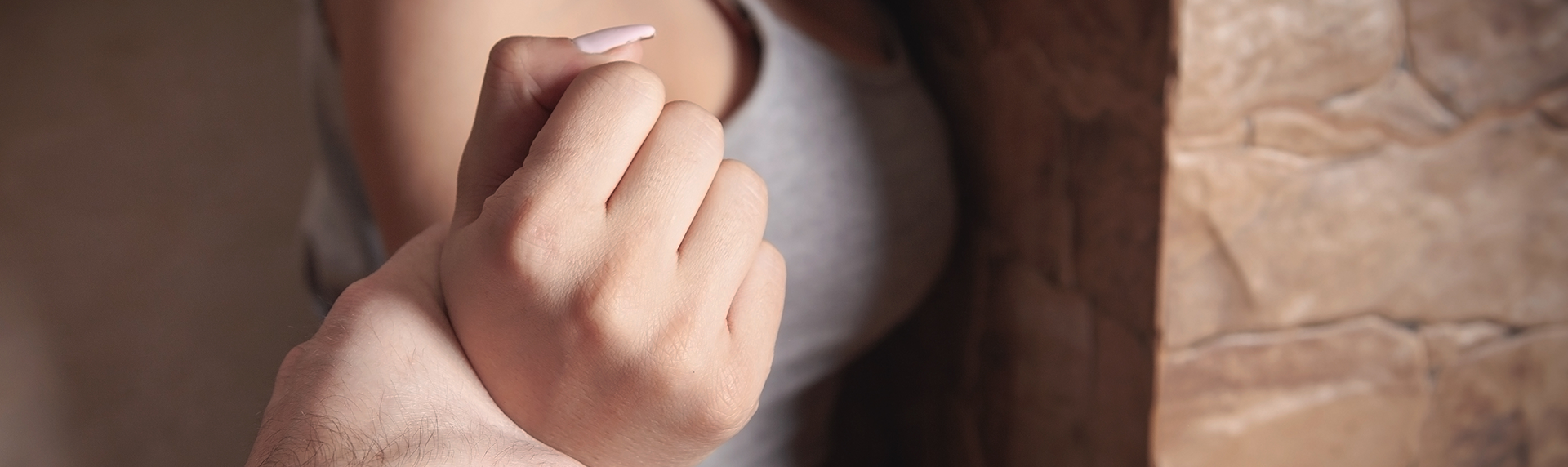 Angry male hand holding a woman hand Abuse victim - domestic abuse lawyers concept image
