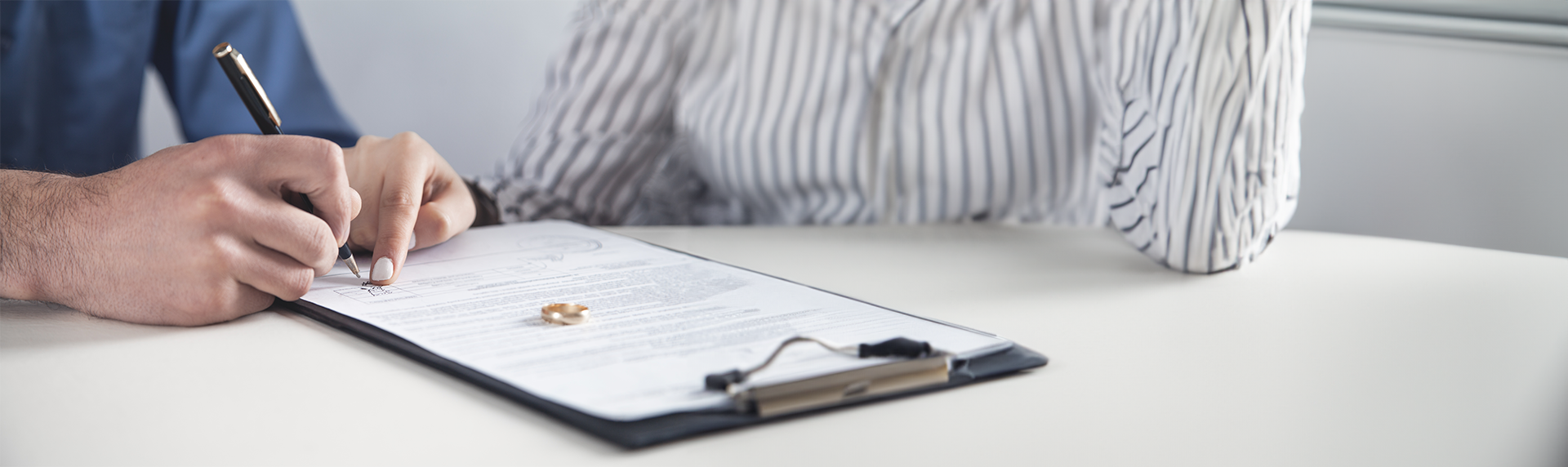 man signing papers with East Hanover Divorce Attorneys
