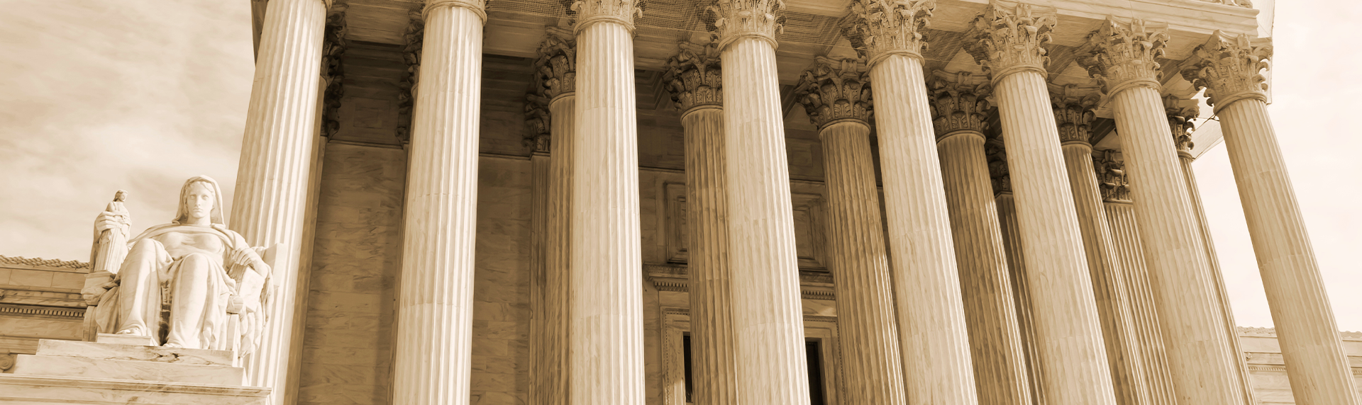Sepia-toned image of the U.S. Supreme Court building's facade, featuring tall, ornate Corinthian columns. A statue of a seated figure holding a tablet is visible on the left, symbolizing justice, as if awaiting a skilled criminal defense lawyer. The architecture is grand and imposing.