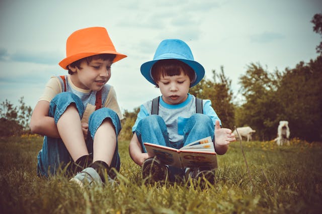 two kids outside reading